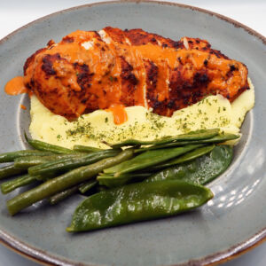 Char grilled Peri spiced chicken breast served with creamy mash and steamed greens