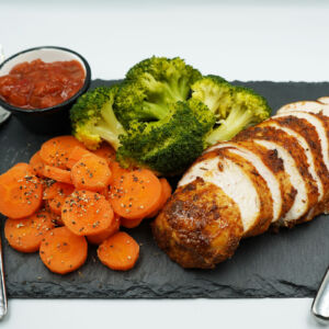 Grilled Cajun chicken breast with seasoned and steamed broccoli and carrots and chunky salsa