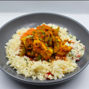 Chicken tikka karahi with Cauliflower rice, steamed carrots and Yoghurt Raita.