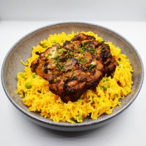 Char-grilled jerk style chicken thighs served with spicy rice and mint sauce.