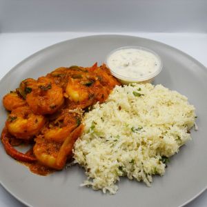 king prawn masala served with cauliflower rice and yoghurt raita.