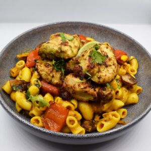 Spicy Mac n Cheese served with cilantro and lime chicken tikka.