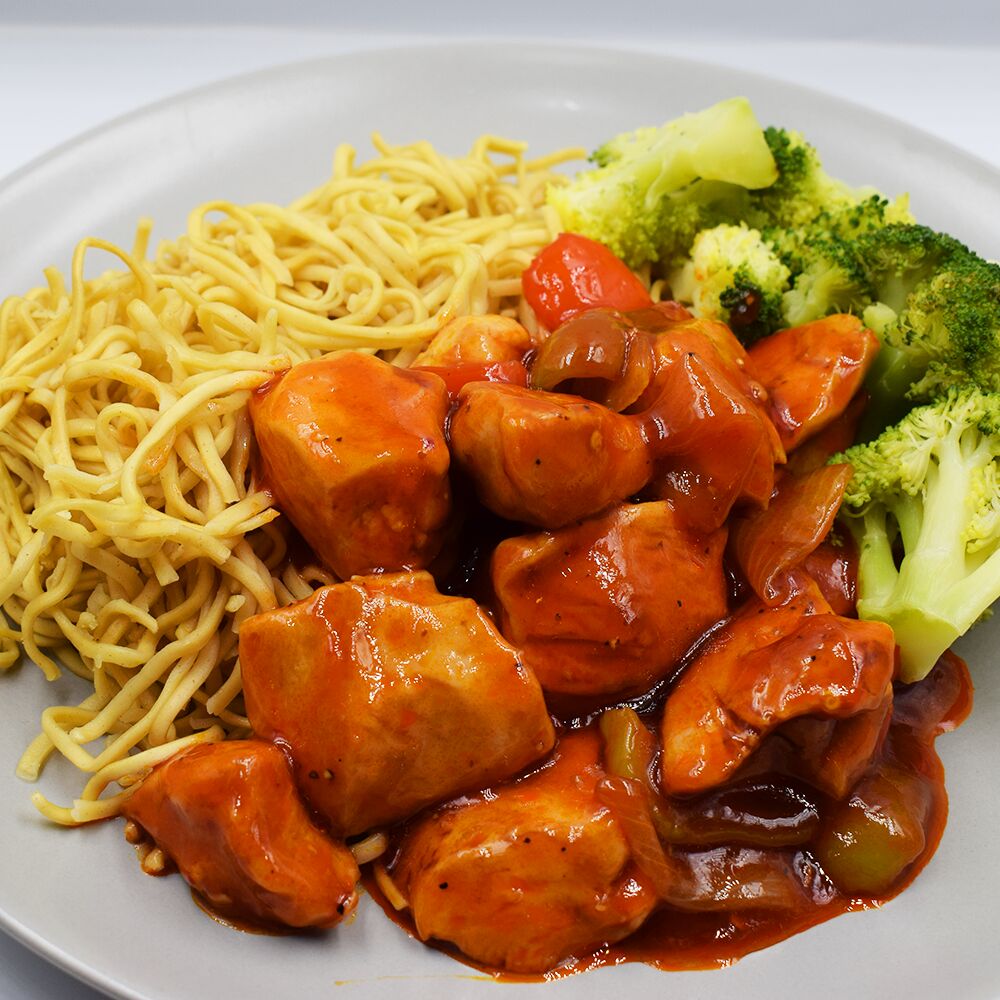 Sweet and sour style chicken served with noodles and steamed broccoli.