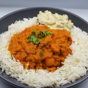 Chicken tikka butter masala served with steamed basmati and yoghurt raita.