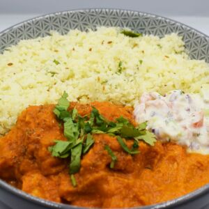Chicken tikka butter masala served with cauliflower rice and yoghurt raita.