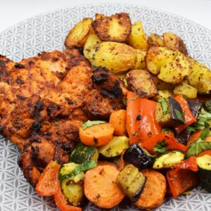 Med style chicken thighs served with roasted baby potatoes and pesto veg.